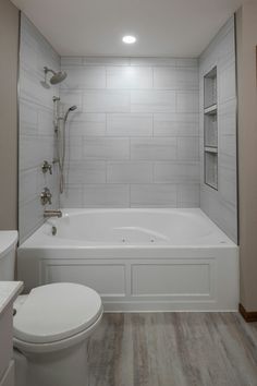 a bathroom with a toilet, bathtub and shower stall in it's corner