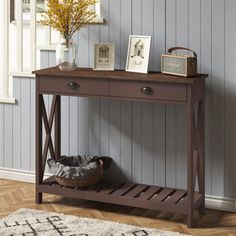 a wooden table sitting on top of a hard wood floor next to a white rug