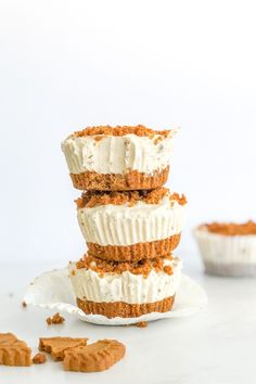 three cupcakes stacked on top of each other with frosting and graham crackers