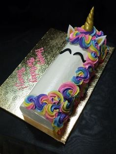 a birthday cake with a unicorn face on it