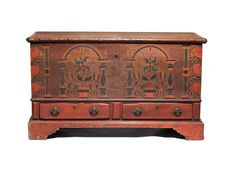 an old wooden chest with carvings on the front and side panels, all painted red