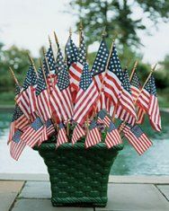 a basket filled with american flags next to a pool