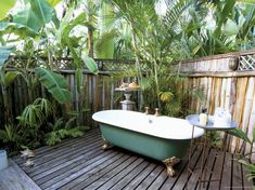 a bath tub sitting on top of a wooden deck