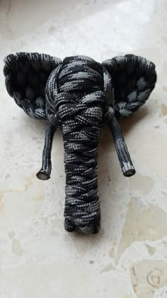 an elephant's head is made out of rope and sits on a marble surface