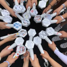 a group of people standing around each other holding nintendo wii game controllers in their hands