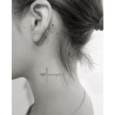 a woman's neck with the word hope tattooed on her left side behind her ear