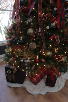 a decorated christmas tree with presents under it