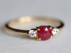 Ruby ring, Engagement ring, Ruby engagement ring, Diamond and Ruby stacking ring, Natural ruby ring, dainty promise ring, ruby ring Same design can be made also with other custom gemstones per request. Product details: - Solid gold (9k, 14k) - approx 5mm ruby round - 2.5mm Diamonds ( G, VS-SI ) - Band size is 1.4mm - Made to order - 8 to 10 business days. Ring size - US 3 to US 9 (for smaller or larger ring size, please contact) Please select your size at the drop down menu. Service Available - Luxury Red Three Stone Jewelry, Luxury Red Three-stone Jewelry, Luxury Ruby Three Stone Rings, Classic Red Three Stone Diamond Ring, Classic Red Three Stone Rings, Classic Red Promise Ring, Classic Red Three-stone Ring, Formal Red Ruby Ring With Three Stones, Formal Ruby Three Stone Ring