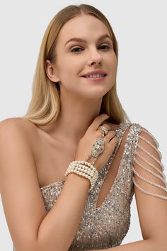 This sumptuous piece of jewelry features a retro-elegant yet slightly modern style that complements the lavish garments, reminiscent of the roaring 1920s. Features: High quality Austrian crystals and imitation pearls Four strand design Inner perimeter of bracelet is 7.4"/ 18.8cm Diameter of ring: 0.7"/ 1.78cm Elegant Crystal Bracelet For Party, Glamorous Pearl Jewelry For Formal Occasions, Elegant Beaded Bling Bracelets For Party, Elegant Beaded Bangle Bracelets With Bling, Elegant Beaded Bangle Crystal Bracelet, Elegant Beaded Crystal Bangle Bracelet, Glamorous Jeweled Bracelets For Party, Glamorous Evening Bling Bracelets, Elegant Pearl Bracelet For Party