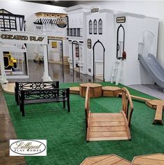 an indoor play area with wooden benches and slides