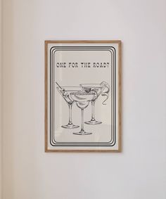 a framed poster with the words one for the road in front of two martini glasses