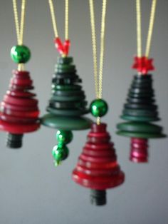 christmas tree ornaments are hanging from strings