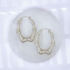 10K Oval Shaped Bamboo Hoop Earrings with White Gold Rhodium* Plating 2 3/4" width, 3" drop Lightweight for all day wear 10K Gold fortified snap bar closure keeps these babies securely closed Engraved with the affirmation "MM Luvs U" Charged in signature crystal grid and infused with Reiki for generational blessings (click for custom crystal grid charging and intuitively focused Reiki ) *Rhodium doesn't easily oxidize, corrode, or react to your skin. It's nickel-free and naturally hypoallergenic Everyday Oval White Gold Hoop Earrings, Silver Oval Tarnish Resistant Hoop Earrings, Oval 14k White Gold Hoop Earrings, 14k White Gold Oval Hoop Earrings, Oval Nickel-free Hoop Earrings For Anniversary, Nickel-free Oval Hoop Earrings For Anniversary, Nickel-free Hoop Earrings For Anniversary, Oval Metal Hoop Earrings For Everyday, Oval Metal Hoop Earrings