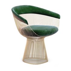 an egg chair with a green cushion on it's back and seat upholstered