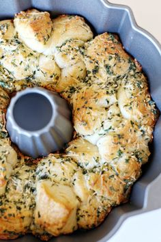 a bundt cake in a pan with herbs sprinkled on top