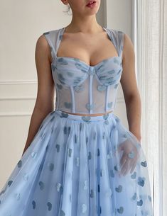 Details:-Baby blue tulle fabric with printed hearts-Two piece dress with detached top and skirt-Corset in a close fitting, with rigilene boning-Tied straps with a decorative bow in the back-Tea length style with side pockets. Fitted Blue Tulle Corset Dress, Blue Summer Corset Dress With Boned Bodice, Spring Party Bodice With Sweetheart Neckline, Blue Tulle Dress With Boned Bodice, Blue Dress With Boned Bodice And Spaghetti Straps, Blue Corset Dress With Sweetheart Neckline And Boned Bodice, Blue Corset Dress For Summer Wedding, Heart Print Dress With Sweetheart Neckline, Blue Summer Wedding Corset Dress