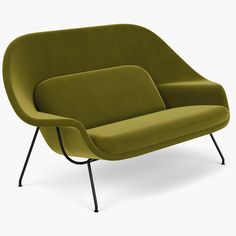 a green couch sitting on top of a metal frame