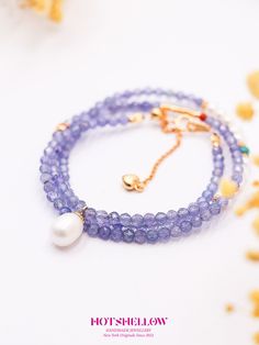 Inspired by the ethereal beauty of a lavender garden, the Violet Elegance Tanzanite Necklace captures the essence of mystery and sophistication. This exquisite necklace features violet tanzanite beads, known for their sparkling facets and deep hues, accented with natural turquoise, freshwater pearls, and South Red Agate. The design is finished with 925 silver plated with gold, creating a harmonious and elegant piece. This necklace embodies the calming and transformative properties of tanzanite. Elegant Blue Amethyst Jewelry, Blue Beaded Amethyst Jewelry, Lavender Tanzanite Jewelry For Gifts, Elegant Oval Tanzanite Necklaces, Lavender Jewelry With Faceted Beads For Gift, Lavender Faceted Beads Jewelry For Gifts, Faceted Blue Amethyst Jewelry, Elegant Lavender Necklaces With Gemstone Beads, Blue Beaded Amethyst Necklace