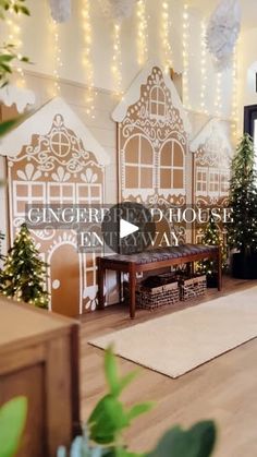 a living room decorated for christmas with gingerbread houses on the wall and trees in the corner