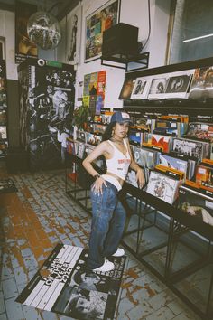 a young woman standing on top of a skateboard in a room full of books