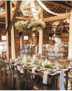 the reception tables are set up with white linens and greenery for an elegant look