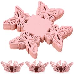 pink butterfly shaped cookie cutters with cut outs on top and four smaller ones in the middle