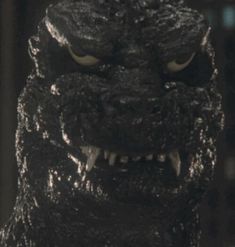 a close up of a godzilla face with its mouth open