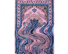 an intricately designed rug with blue and pink colors on the bottom, is shown