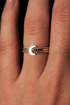 Dive into the celestial charm of our Moon Ring! The lunar-inspired design features a dainty moon on a simple, textured band - providing an adorable accent to any stack. The band measures approximately 1mm in width and features a lightly hammered finish. The moon detail measures approximately 6mm in width. This listing is for ONE SINGLE Moon Ring in STERLING SILVER metal. This ring is a great alternative to a stacking ring and is a perfect ring to mix and match with your favorite stacking rings. Every piece is organic and unique — no two Hannah Naomi pieces are exactly alike.Hand-crafted to order in our Portland, OR studio. Minimalist Adjustable Crescent Ring, Minimalist Crescent Moon Charm Ring, Dainty Moon-shaped Midi Promise Rings, Adjustable Moon-shaped Midi Promise Rings, Minimalist Adjustable Ring With Moon Charm, Adjustable Moon Charm Promise Ring, Minimalist Adjustable Rings With Moon Charm, Adjustable Moon-shaped Promise Ring, Dainty Moon-shaped Promise Ring