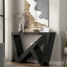 a modern console table with an abstract painting on the wall behind it in a living room