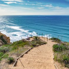 stairs lead down to the beach and ocean