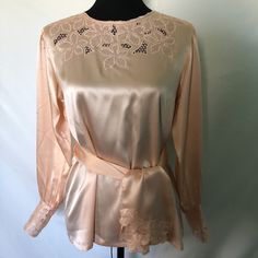 I am offering a mid 1970s Chinese  pink silk blouse. This item includes a sash/scarf. It is long sleeved with deep cuffs with embroidery and open work. The embroidery and open work are echoed at the neckline and sash ends. It buttons at back with covered buttons. Measurements: Bust 40 in. Waist 39 in. Hips 44 in. Length 25 in. Pink Silk Blouse For Daywear, Long Sleeve Satin Top For Wedding, Long Sleeve Satin Blouse For Daywear, Satin Long Sleeve Blouse For Daywear, Vintage Satin Tops For Spring, Long Sleeve Pink Satin Top, Pink Long Sleeve Satin Top, Pink Satin Long Sleeve Tops, Vintage Long Sleeve Satin Blouse