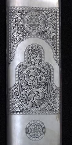 a silver flask with intricate designs on it