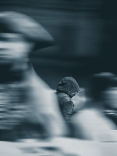 a blurry image of a person walking with an umbrella