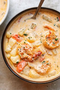 a bowl filled with shrimp and pasta soup