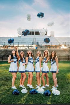 the cheerleaders are all dressed in blue and white