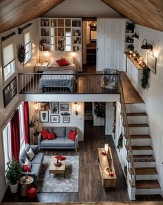 an overhead view of a living room and bedroom area in a tiny house with stairs leading up to the second floor