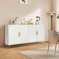 a white cabinet sitting in the middle of a living room next to a table and chairs