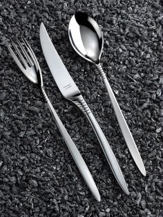 three forks and two spoons on the ground