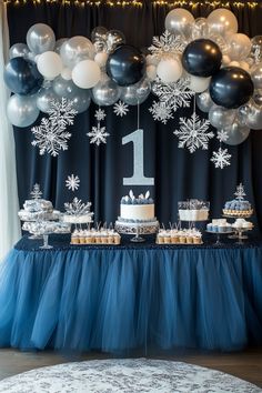 a table topped with cake and cupcakes covered in frosted snowflakes