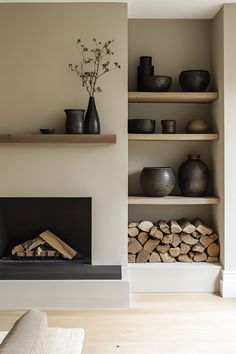 a living room filled with lots of wooden furniture and shelves next to a fire place