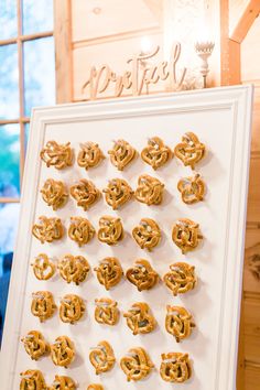 pretzels are arranged in the shape of hearts on a white framed display board