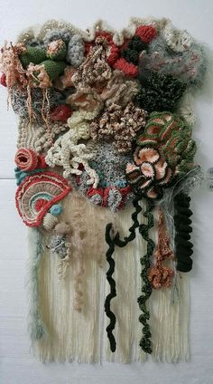 a piece of art made out of different types of yarns and crochet