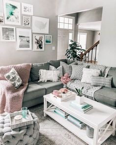 a living room filled with furniture and pictures on the wall above it's coffee table