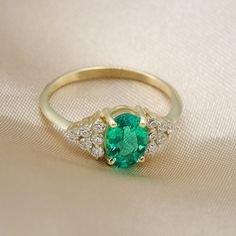 "Handmade by an inspired jewelry artist team with decades of experience in the craft of jewelry making. Each gemstone, each diamond is carefully picked. Using only the finest raw materials and the highest industry standard in manufacturing, design and finish. Emerald oval gemstone and diamonds 14K gold ring. showcasing a beautiful oval cut Colombian Emerald. Engulfed on both sides with white diamond full of fire and sparkle. Gemstone info: ------------------------------ √ Oval cut, prong set. Co Exquisite Oval Emerald Ring With Accent Stones, Yellow Gold Emerald Ring With Oval Shape For Promise, Oval Emerald Ring In Yellow Gold For Promise, Fine Jewelry Oval Diamond Promise Ring, Oval Halo Ring For Promise In Fine Jewelry Style, Exquisite Oval Emerald Ring With Diamond Accents, Oval Halo Ring For Promise - Fine Jewelry, Oval Diamond Promise Ring In Fine Jewelry Style, Oval Halo Ring For Promise Occasion