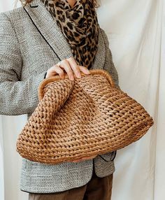 Trendy raffia Pelmeni clutch bag with soft, voluminous pleats that completely hide the model's frame, giving it a rounded shape. A model for stylish women living in big cities, for whom practicality is as important as beauty. Take her to work in the office or to deal with everyday worries. Closes with magnets. Inside: one compartment inside. Cloud bag is available to order in sizes: S: Height - 5.90 inches (15cm) The width of the bag itself is 7.87 inches (20 cm) Depth - 3.14 inches (8 cm) M: He Chic Brown Spring Clutch, Spring Clutch With Detachable Handle, Chic Brown Woven Clutch, Woven Clutch Bag For Spring, Spring Woven Clutch Bag, Chic Natural Clutch For Spring, Chic Woven Handheld Clutch, Chic Handheld Woven Clutch, Chic Pouch Bag With Bamboo Handle