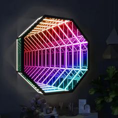 a colorful light up hexagonal mirror hanging on the wall