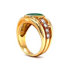 This one of a kind Vintage Inspired Jade & Diamond Ring is crafted in 18k Yellow Gold. A chunky statement ring with Mid-Century style! The jade features a deep forest green hue with rich saturation. The oval shaped cabochon cut jade is set in a bezel. A collection of accent diamonds sparkle at the center of the bold ring. Modern and expertly designed. The ring measures just under 13mm wide. Finished on a tapered and thick 18 karat yellow gold band. A stunning gift for you or your loved one. The Luxury Green Signet Ring With Polished Finish, Luxury Green Dome Ring For Formal Occasions, Luxury Green Signet Ring For Formal Occasions, Jade Diamond Ring, Deep Forest Green, Bold Rings, Yellow Gold Jewelry, Deep Forest, Shop Engagement Rings