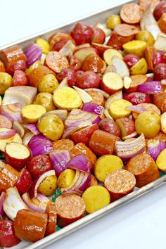 a tray filled with lots of different types of food on top of a white table