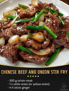 the chinese beef and onion stir fry is served on a white plate